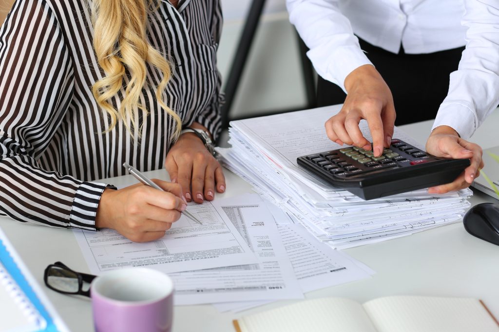 people using calculator for business