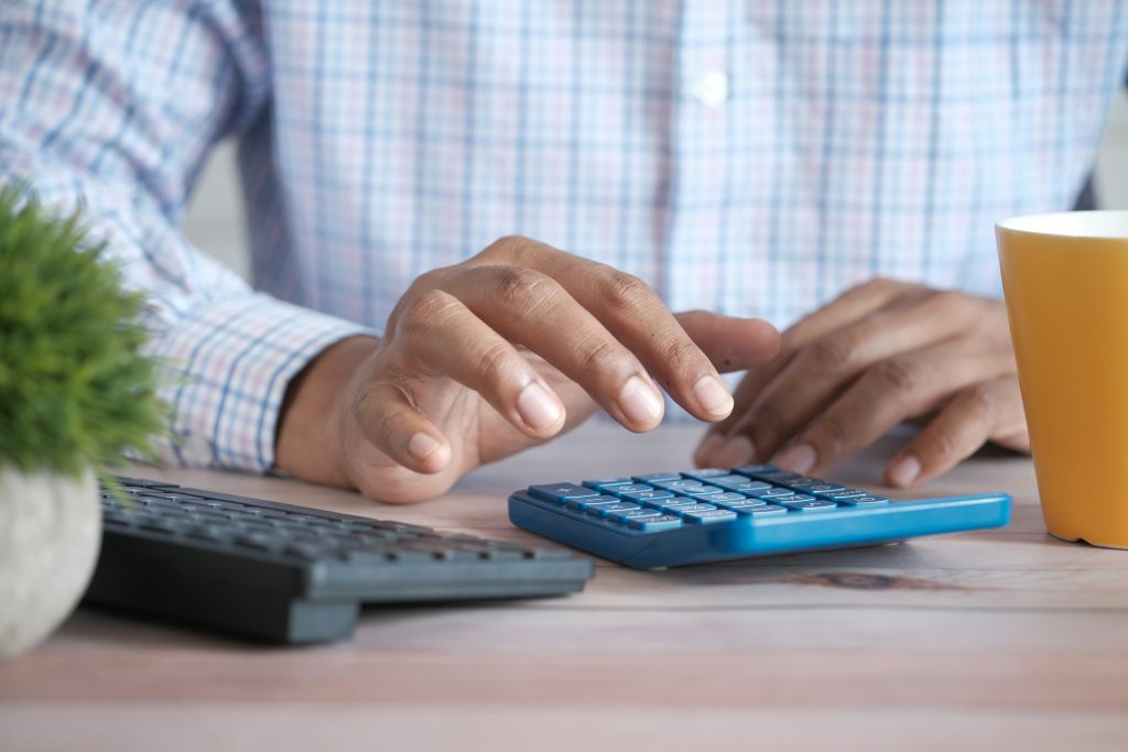 man using calculator for tax